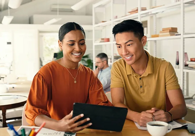 Two people looking at a tablet computer together.