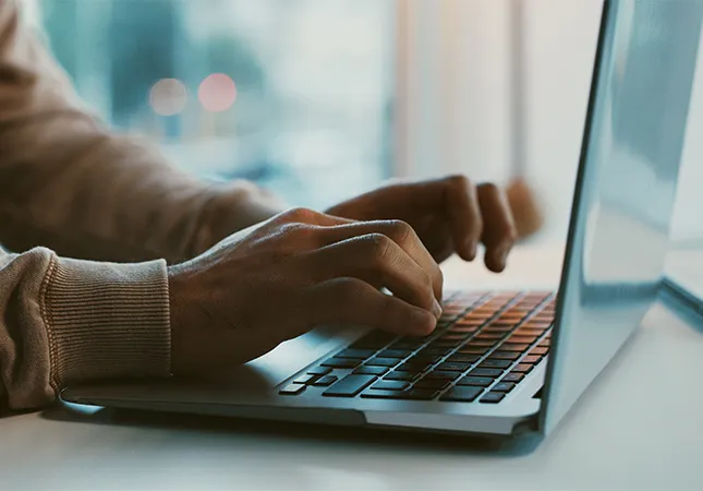 A person typing on a laptop.