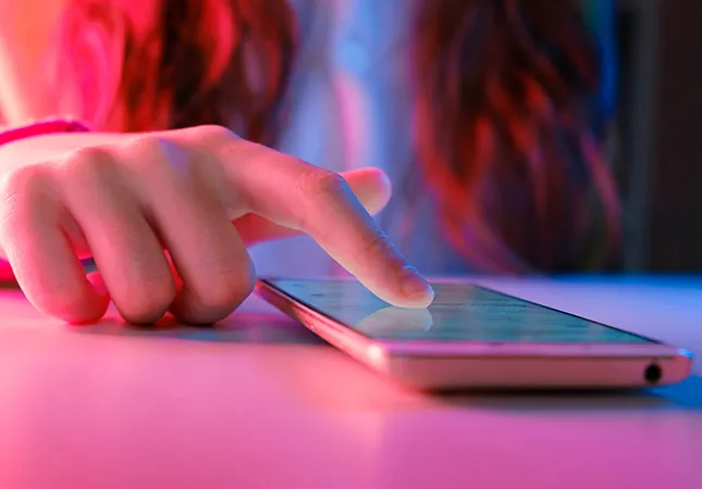 A person using a touchscreen mobile phone.