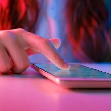 A person using a touchscreen mobile phone.